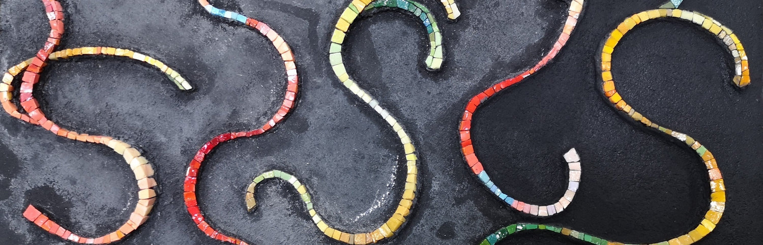 Detail of the mosaic artwork “Don’t Try to Be Nice, Be Real” showing curving colored lines on a dark background, a visual reminder to stop pleasing and start being real.